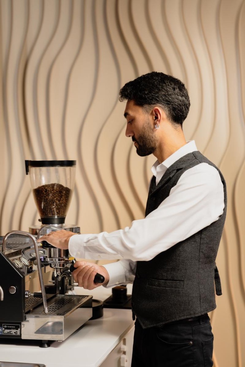 Huseyin preparing espresso at the BrewJoy coffee bar